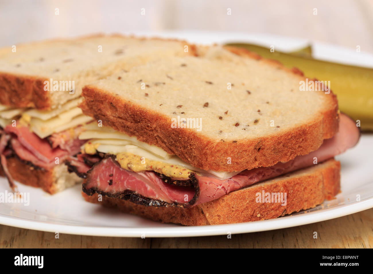 Pastrami sandwich on Jewish Rye bread with swiss cheese, mustard, and
