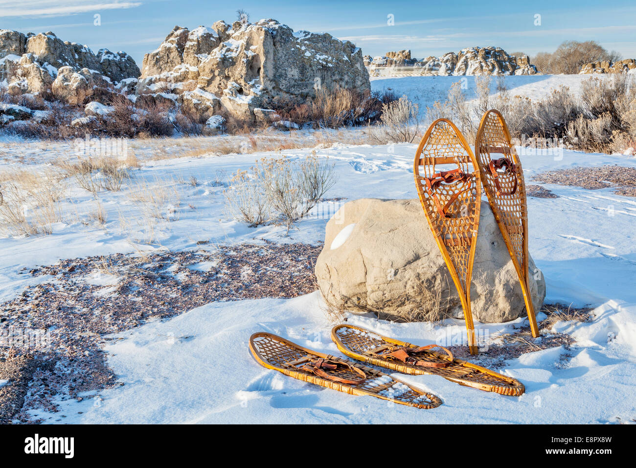 vintage Huron and Bear Paw snowshoes in winter scenery on a parking lot or trailhead Stock Photo