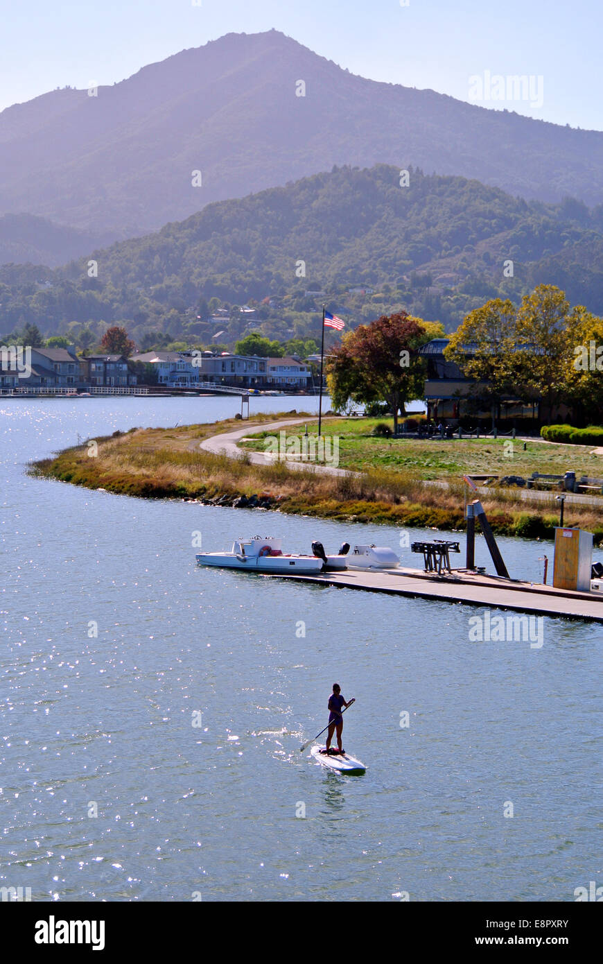 paddle boarder paddles on Corte Madera Creek in Larkspur California Stock Photo