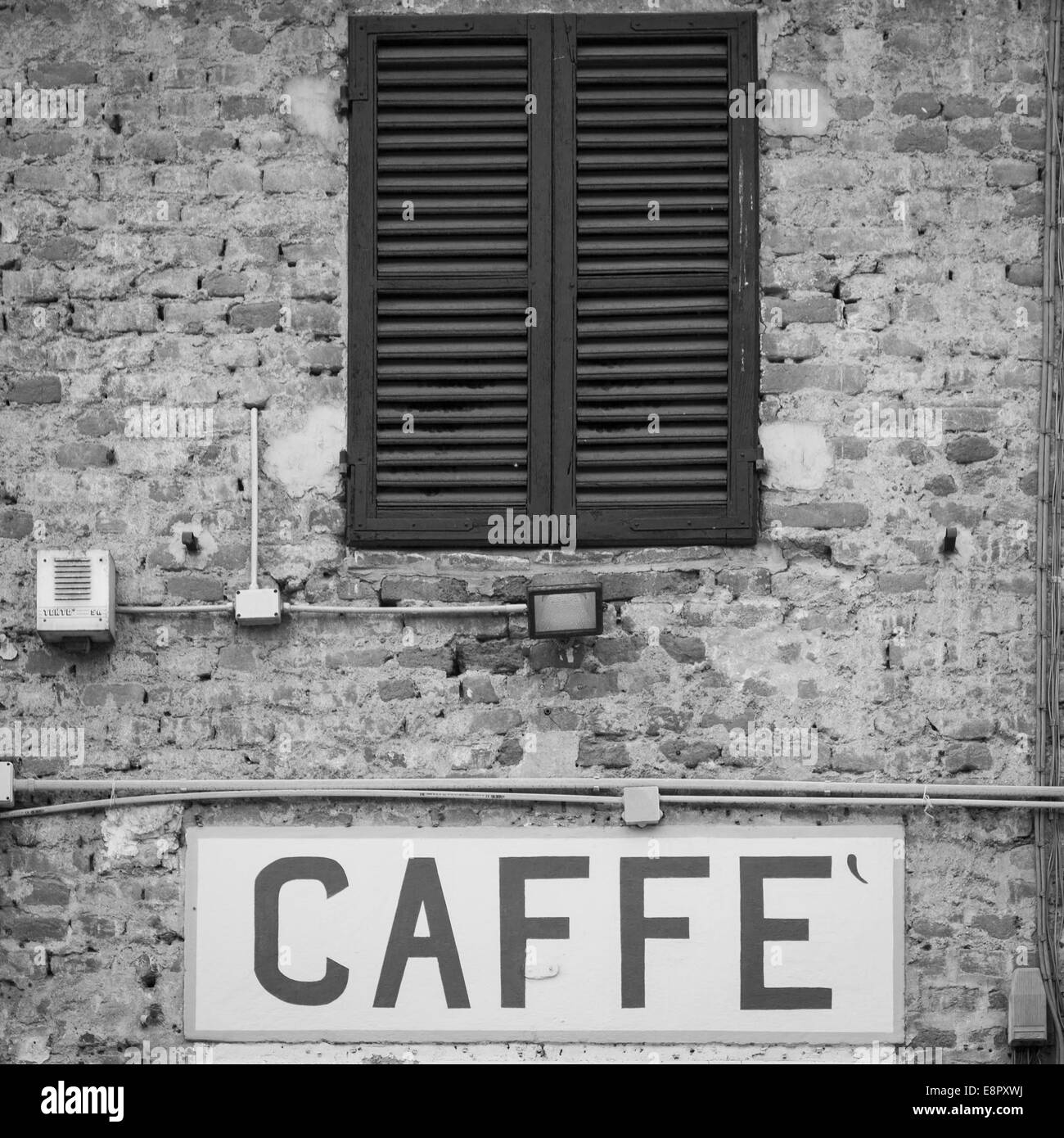 Tuscany, Italy. Old Caffè sign under a traditional Italian window Stock Photo