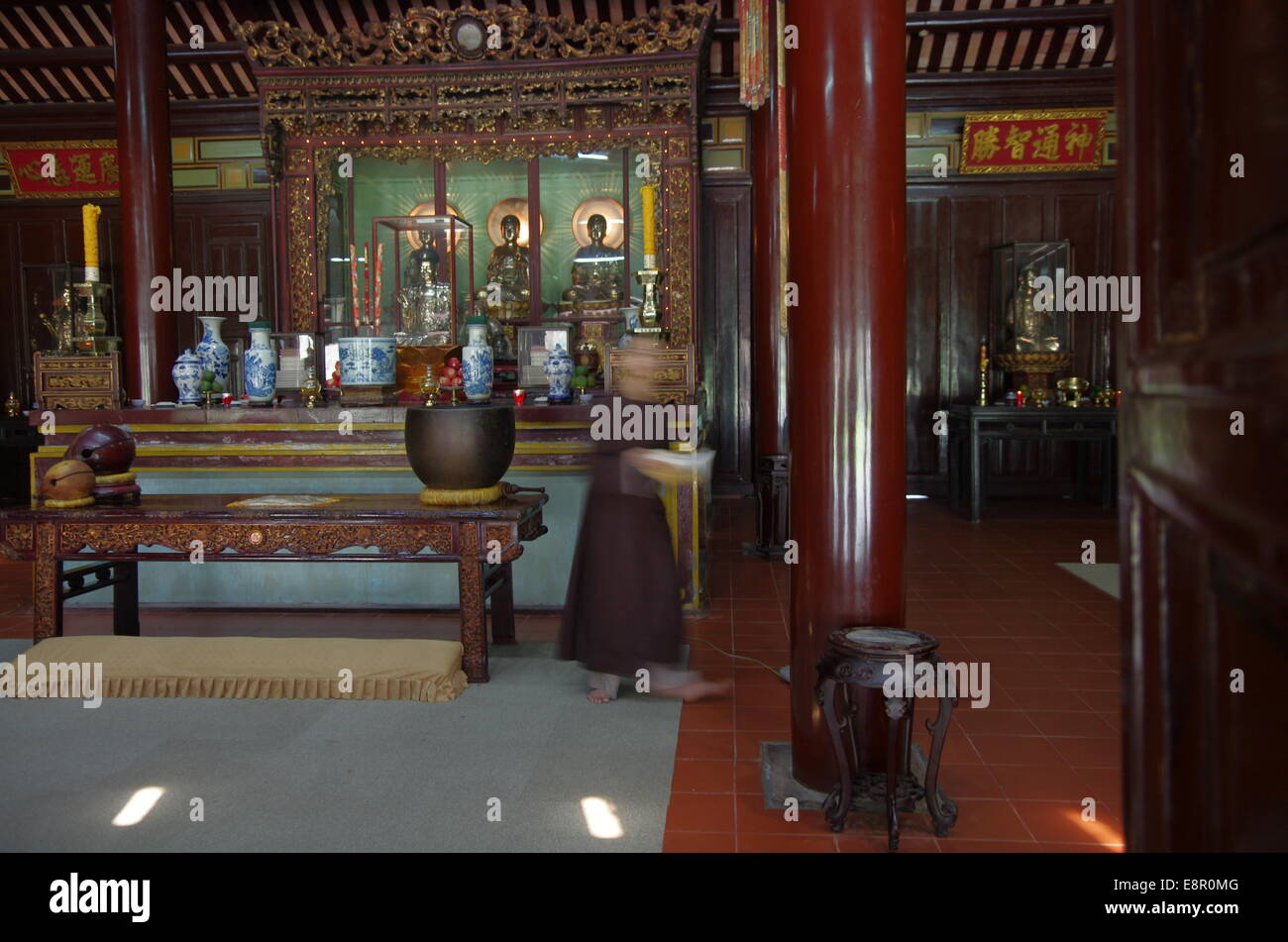 Monk walking away from altar Stock Photo