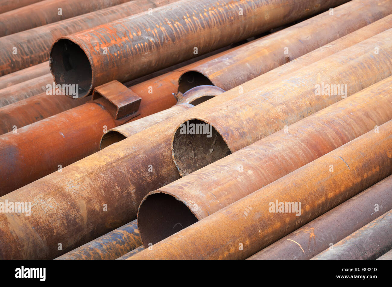 Rusted industrial steel pipes lay on the ground Stock Photo