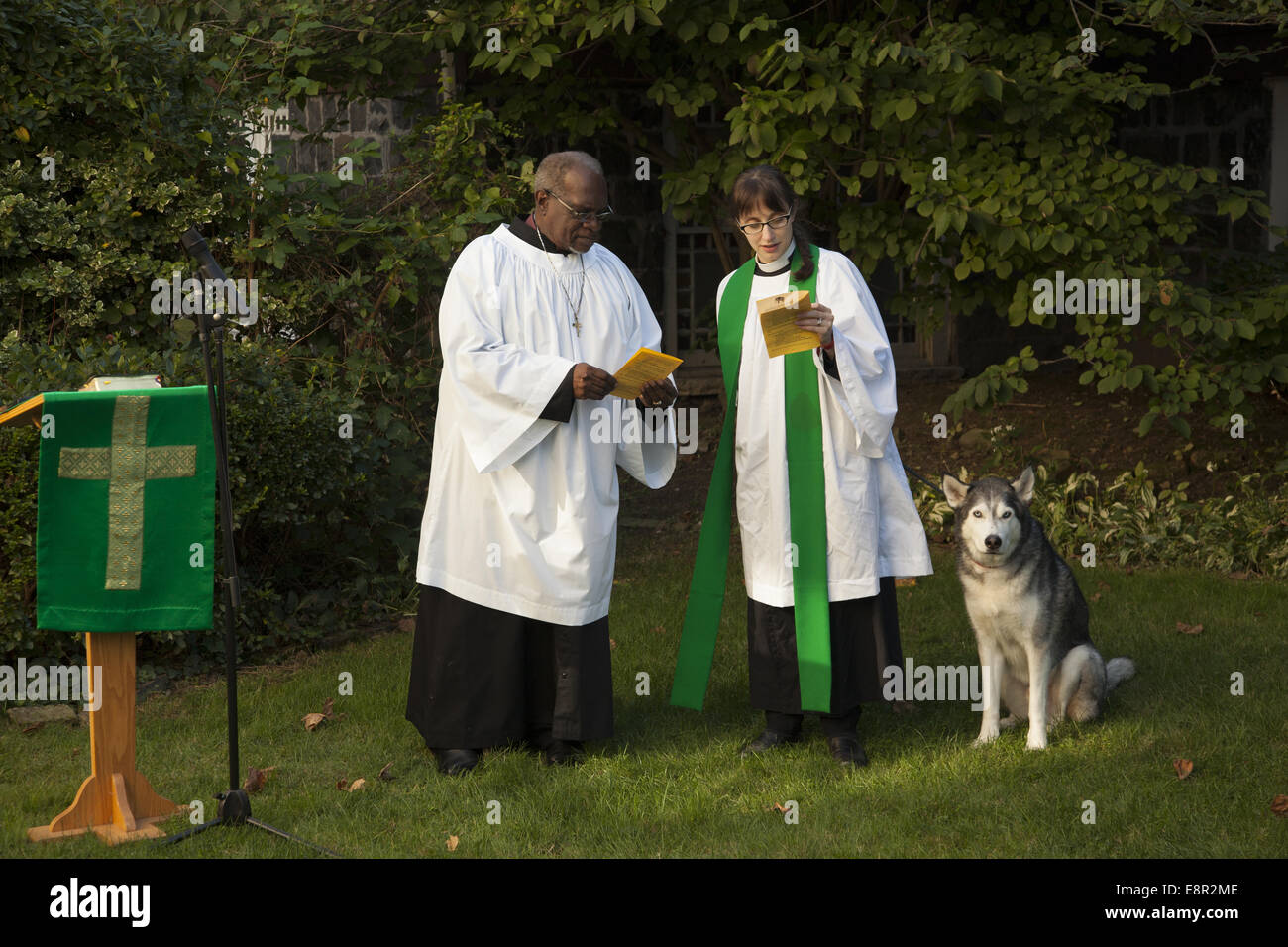 Priests prepare to lead a service in the church garden and bless the animals on Saint Francis of Assisi Day in Brooklyn, NY. Stock Photo
