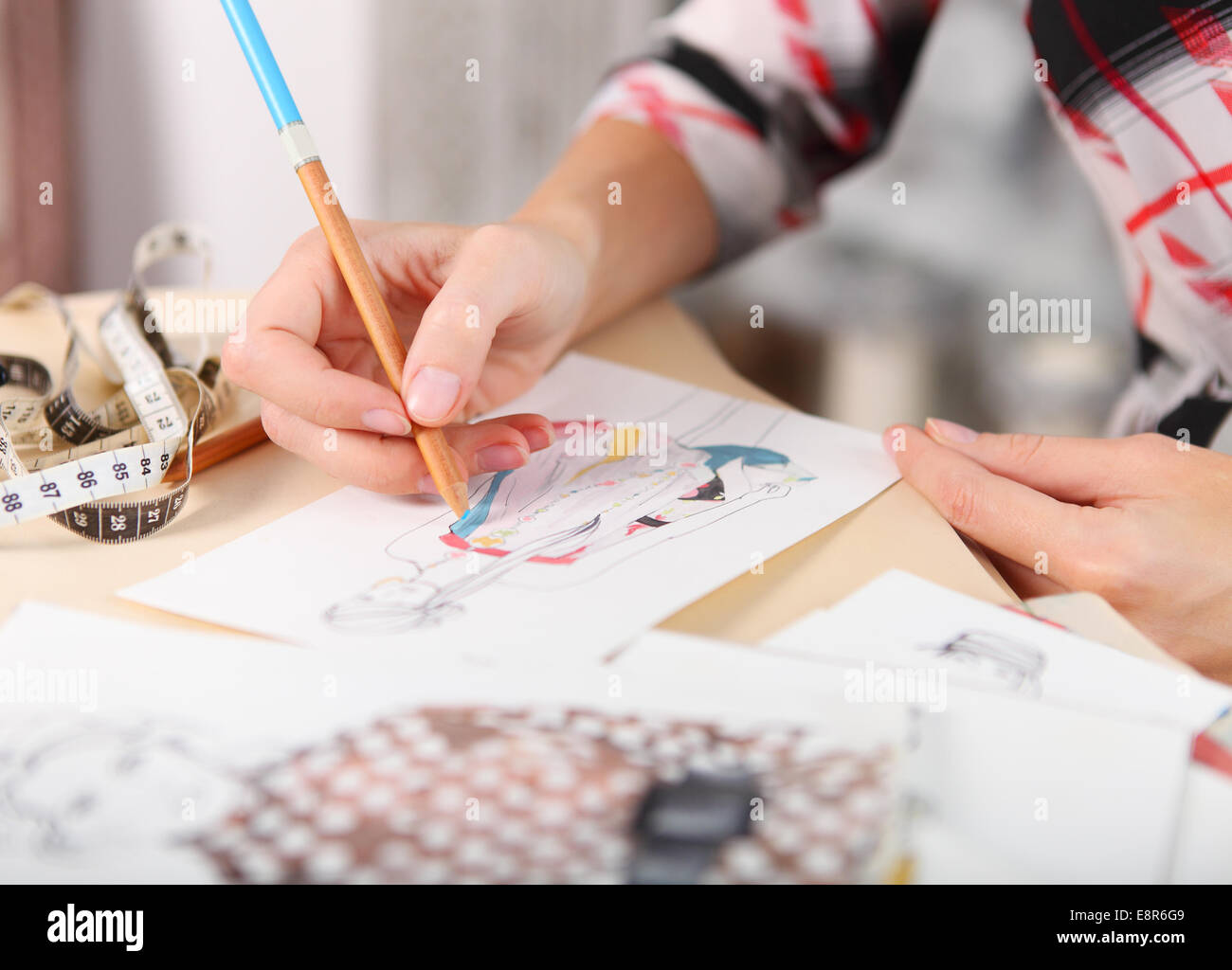 Dressmaker is drawing a fashion sketch. Close up of the hands Stock ...