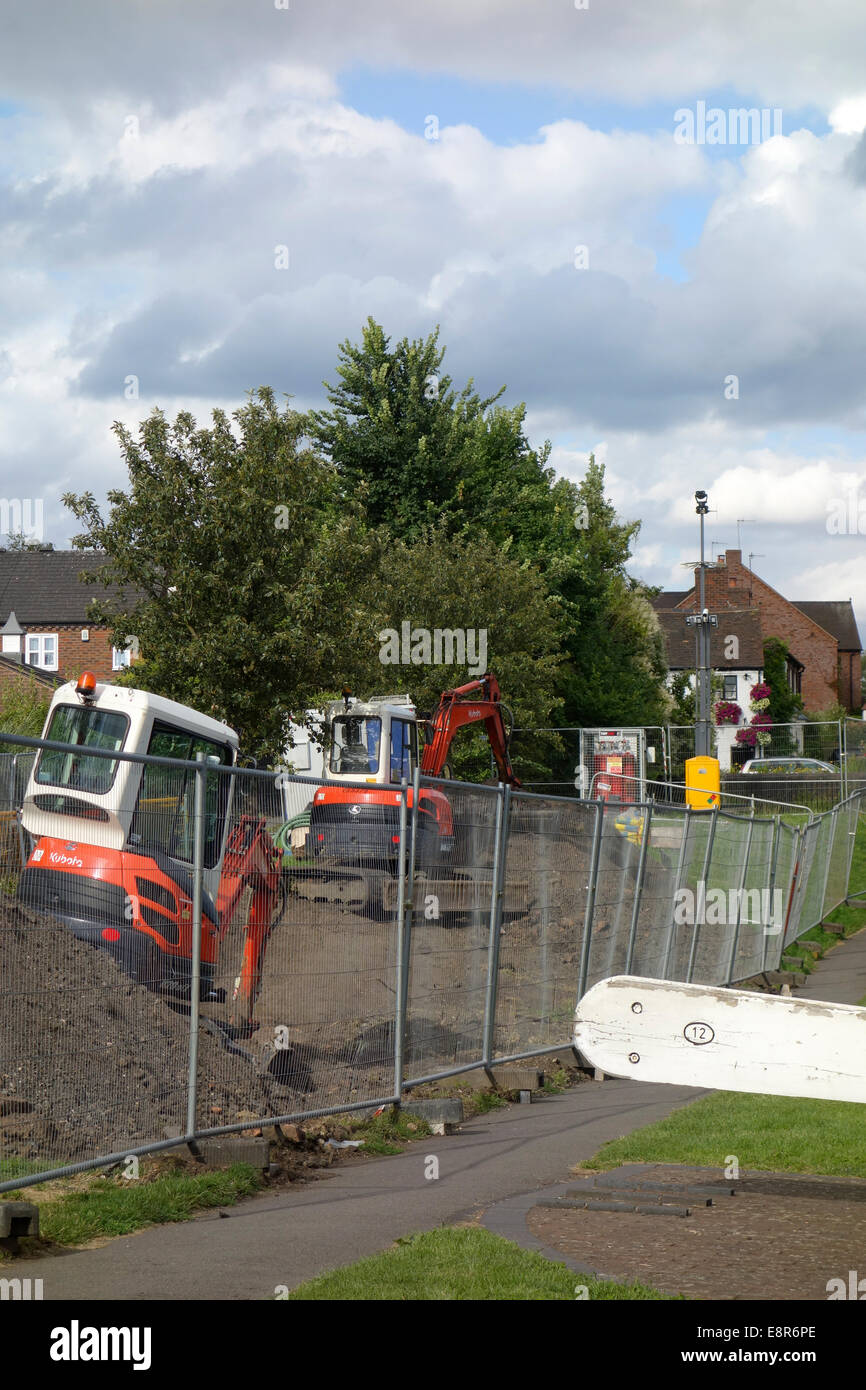 Mini Diggers or Excavators Digging a Trench Alongside Stourbridge Canal