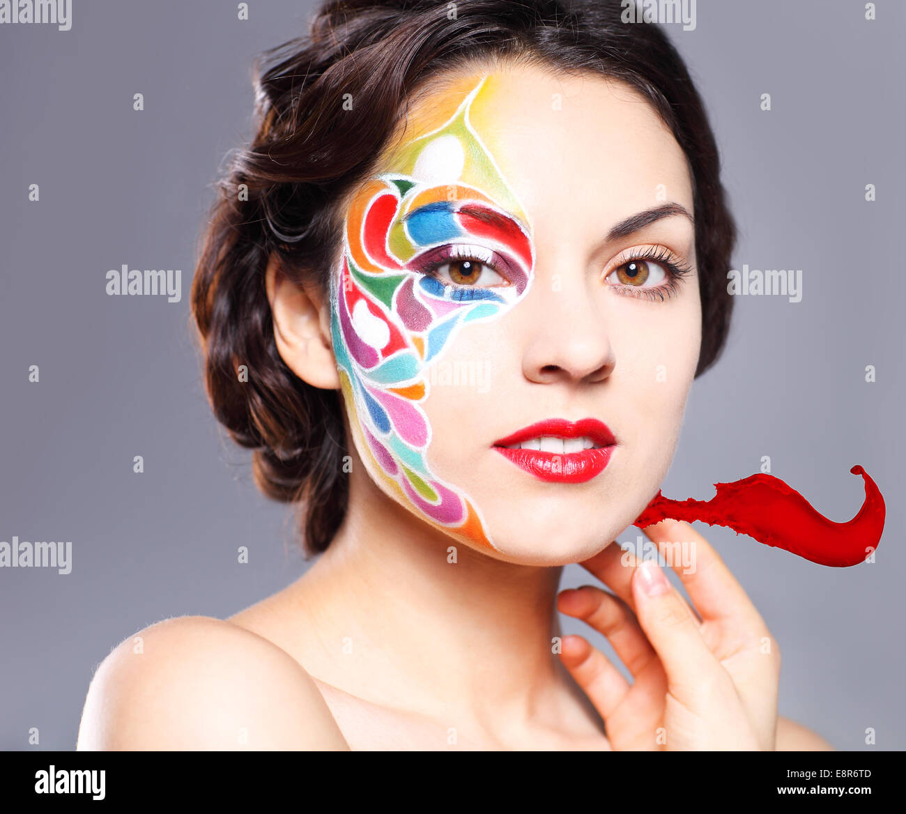 Portrait of a beautiful young model with bright make up and colored ...