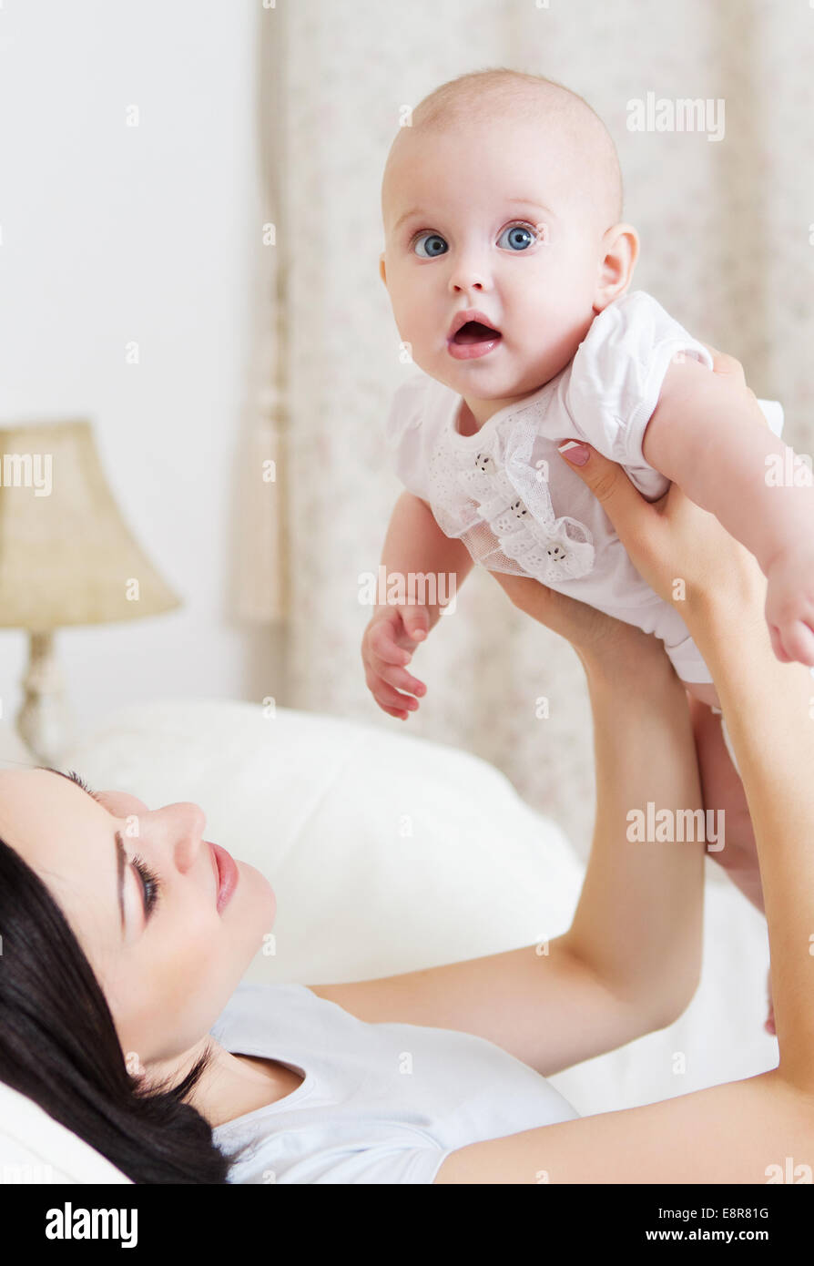 Happy Smiling Mother With Six Month Old Baby Girl Indoor Stock Photo Happy Smiling Mother With Six Month Old Baby Girl Indoor Stock Photo