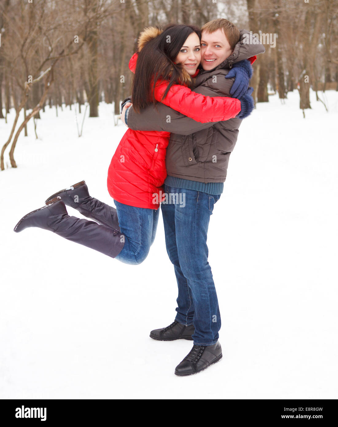 Happy young couple having fun in the winter park Stock Photo - Alamy