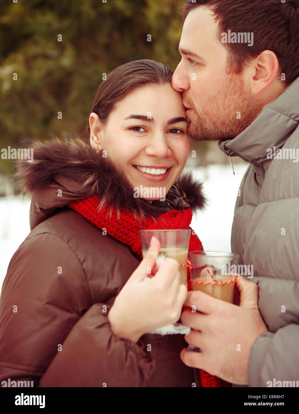 Happy young couple having fun in the winter park Stock Photo - Alamy