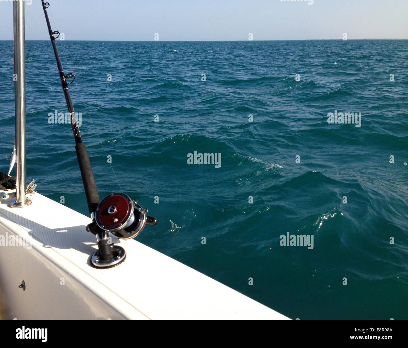 Big game fishing reels and rods in the ocean Stock Photo