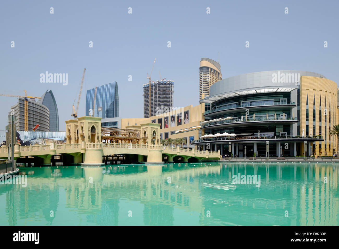 Exterior of Dubai Mall and ornate bridge crossing pond in Dubai United Arab Emirates Stock Photo