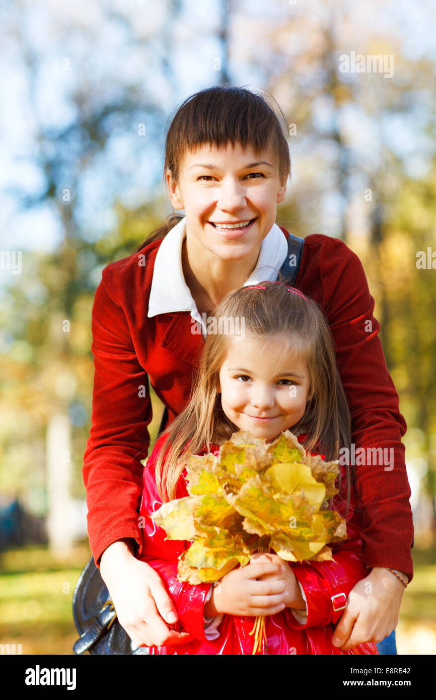 Happy young mother with daughter in autumn park Stock Photo - Alamy