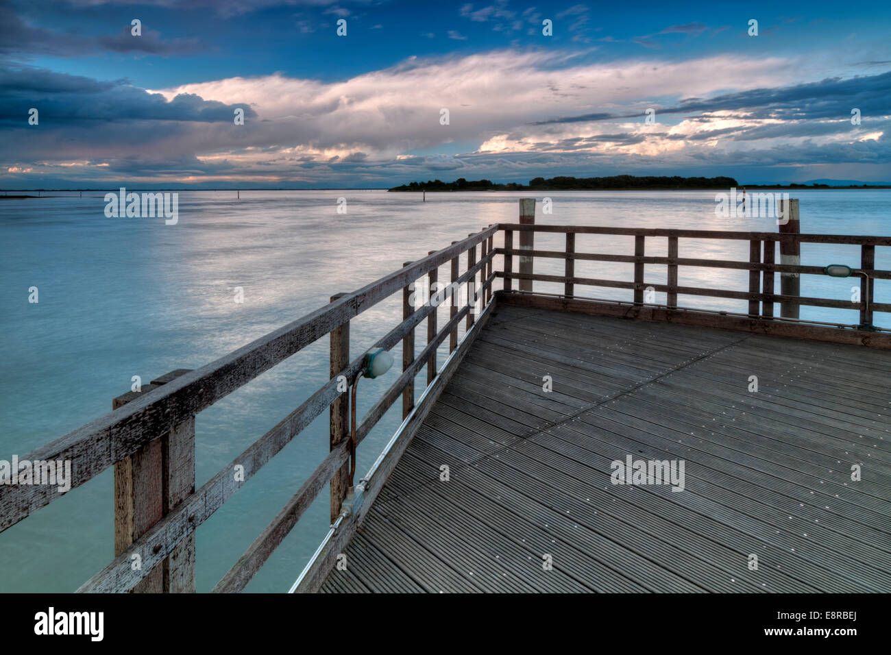 Wooden pier at sunset before sea storm Stock Photo