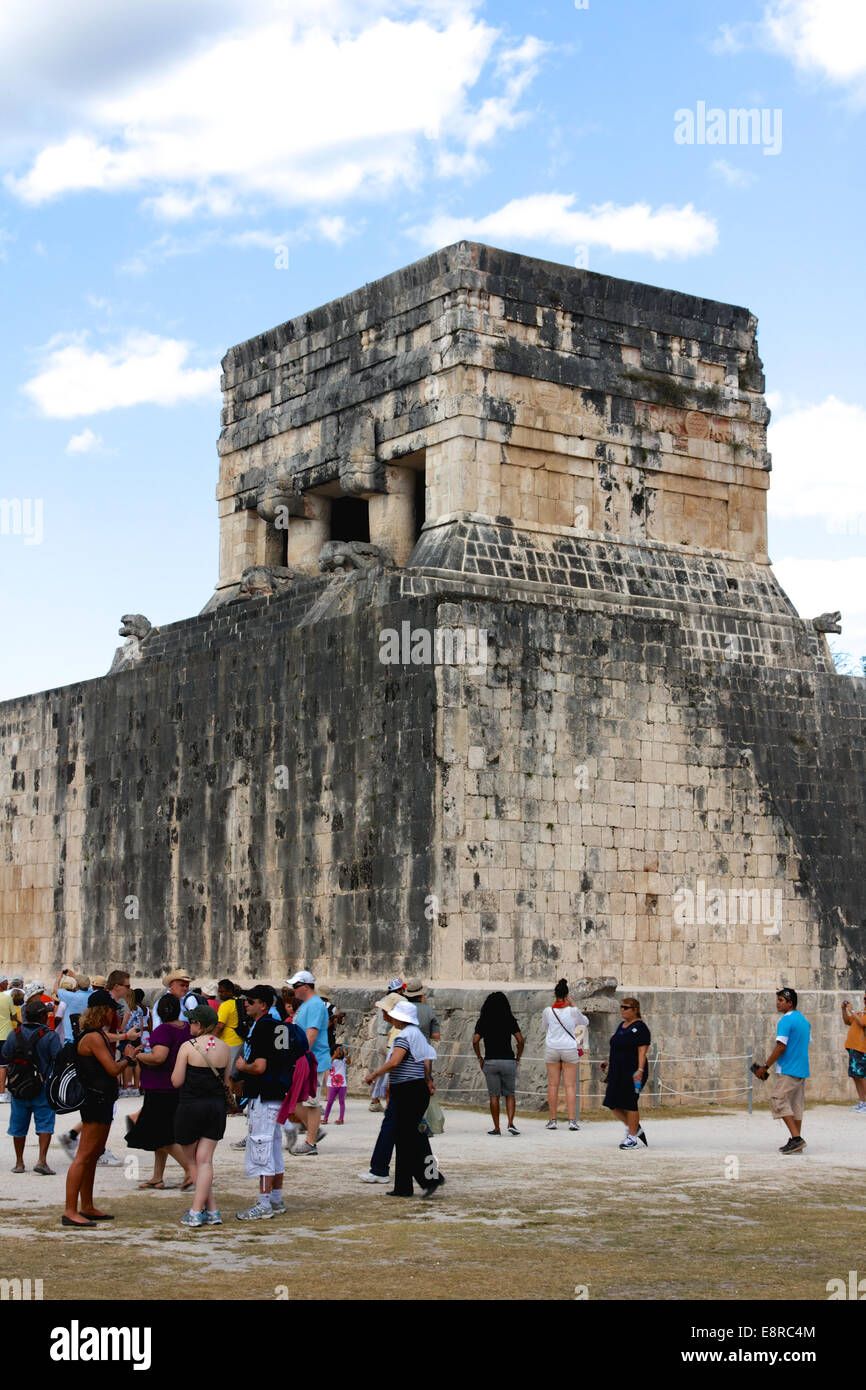 Tourists roam the ancient Mayan ball game Court of the Juego de Pelota ruins at Chicen Itza, Yucatan, Mexico in March 2012. Stock Photo