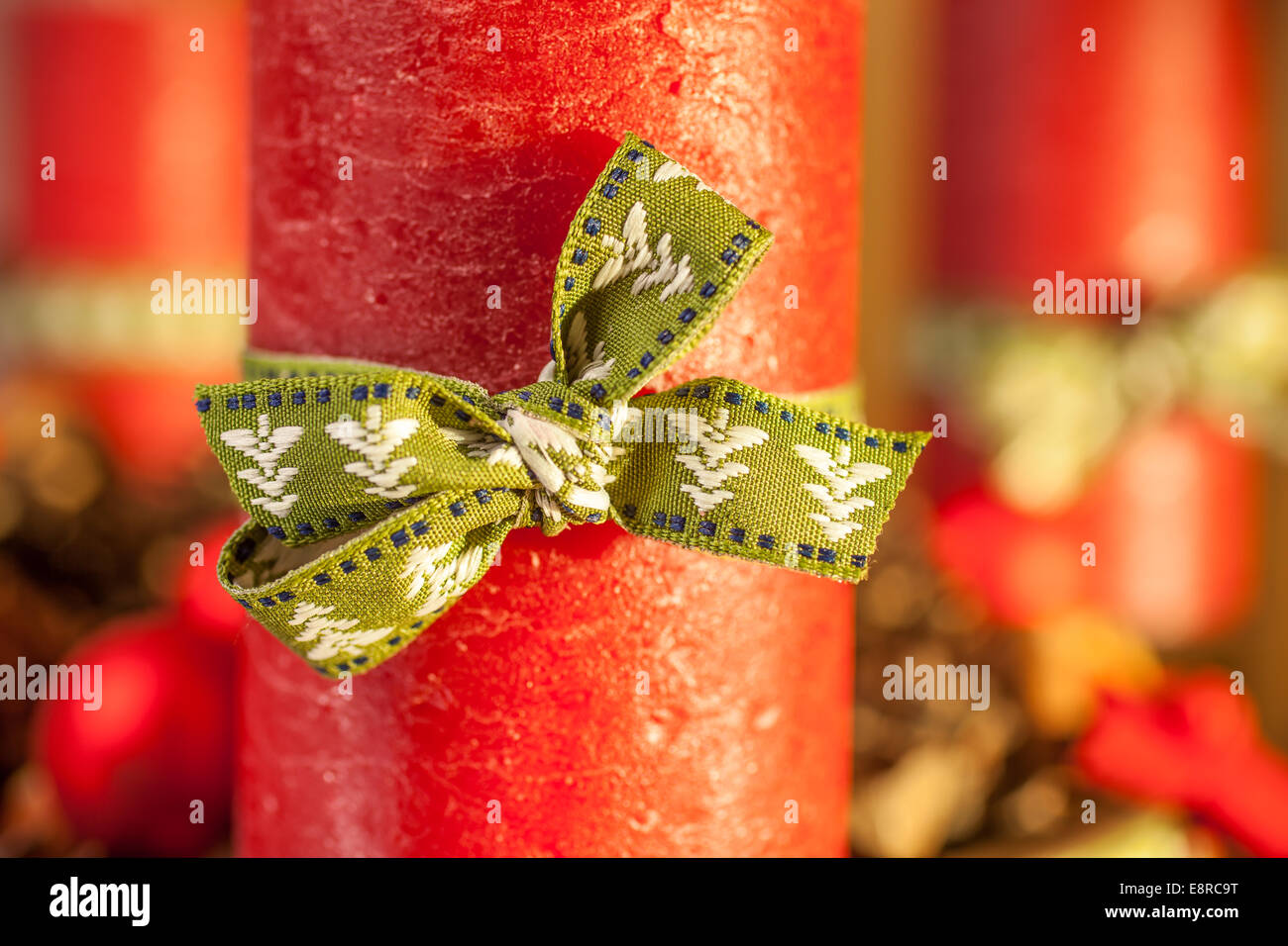 Red candle with green ribbon on advent wreath Stock Photo