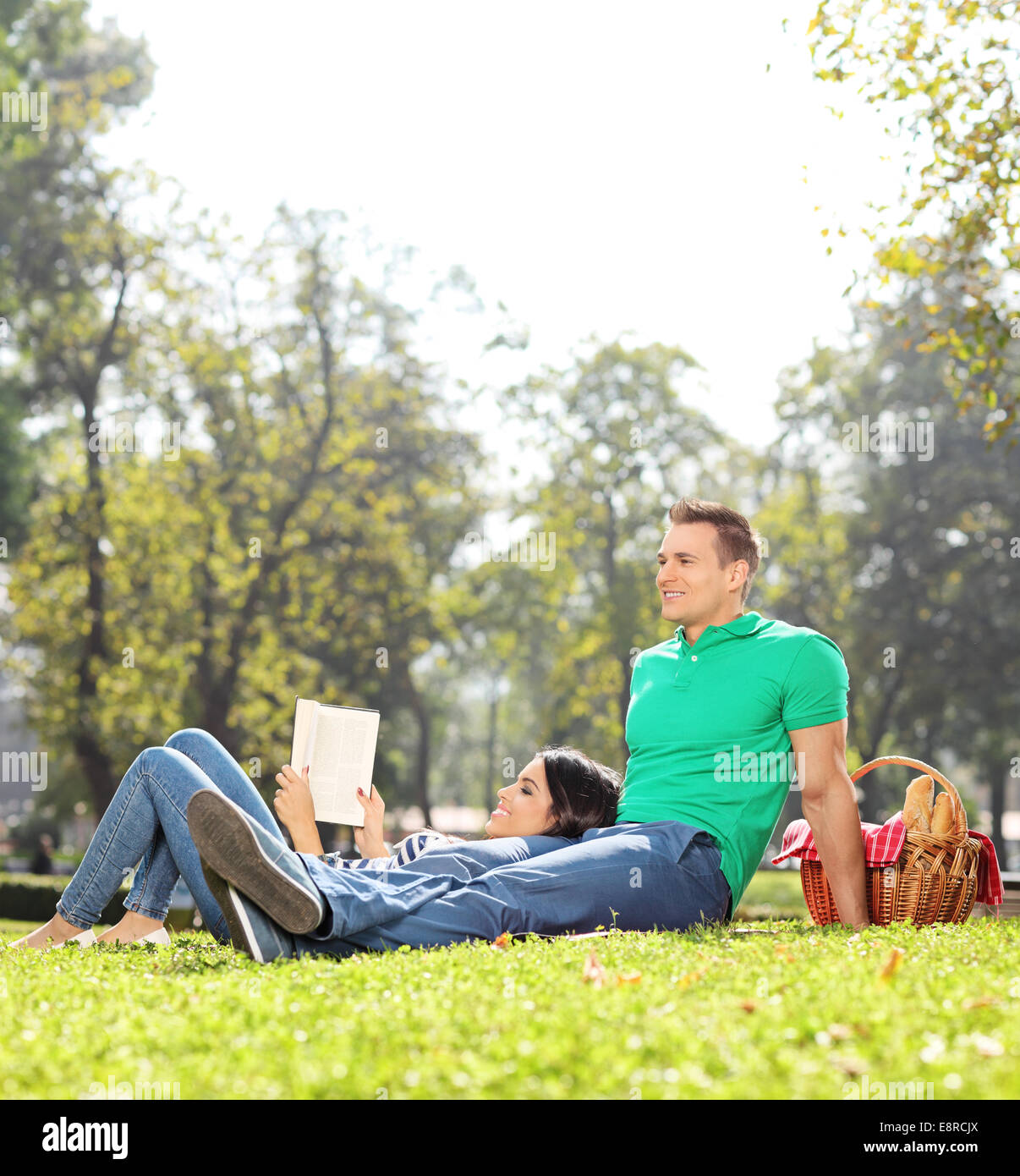 Couple having a picnic on nice sunny day in park shot with tilt and shift lens Stock Photo