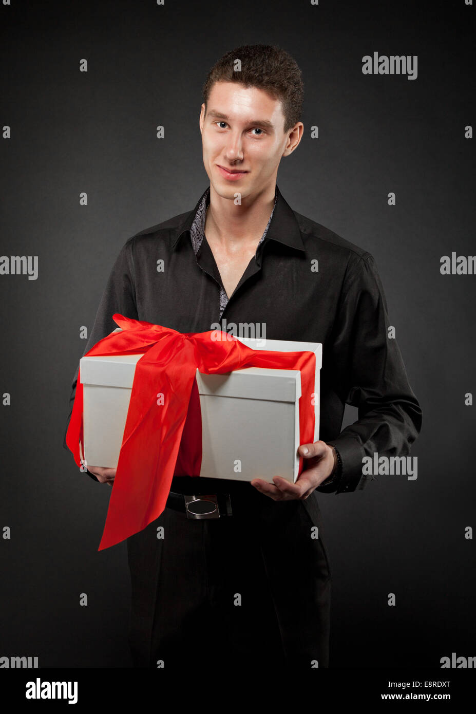 Man With Ribbon Happy young man with present decorated with red ribbon Stock Photo - Alamy