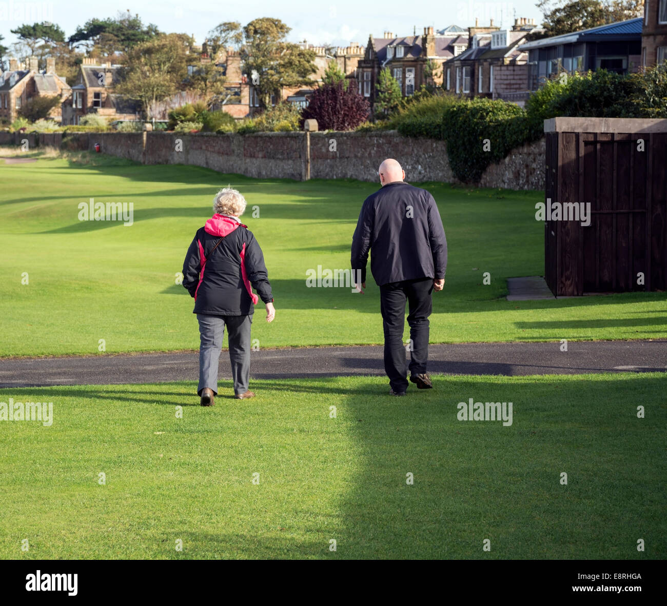 Walkers in the sunshine alongside the west Links golf course at North