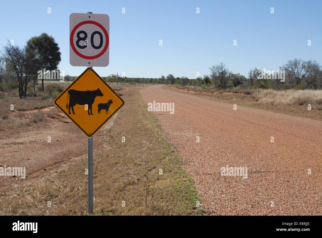 Speed limit and yellow warning road signs on the Urdera Road near Charters Towers, Queensland, Australia Stock Photo