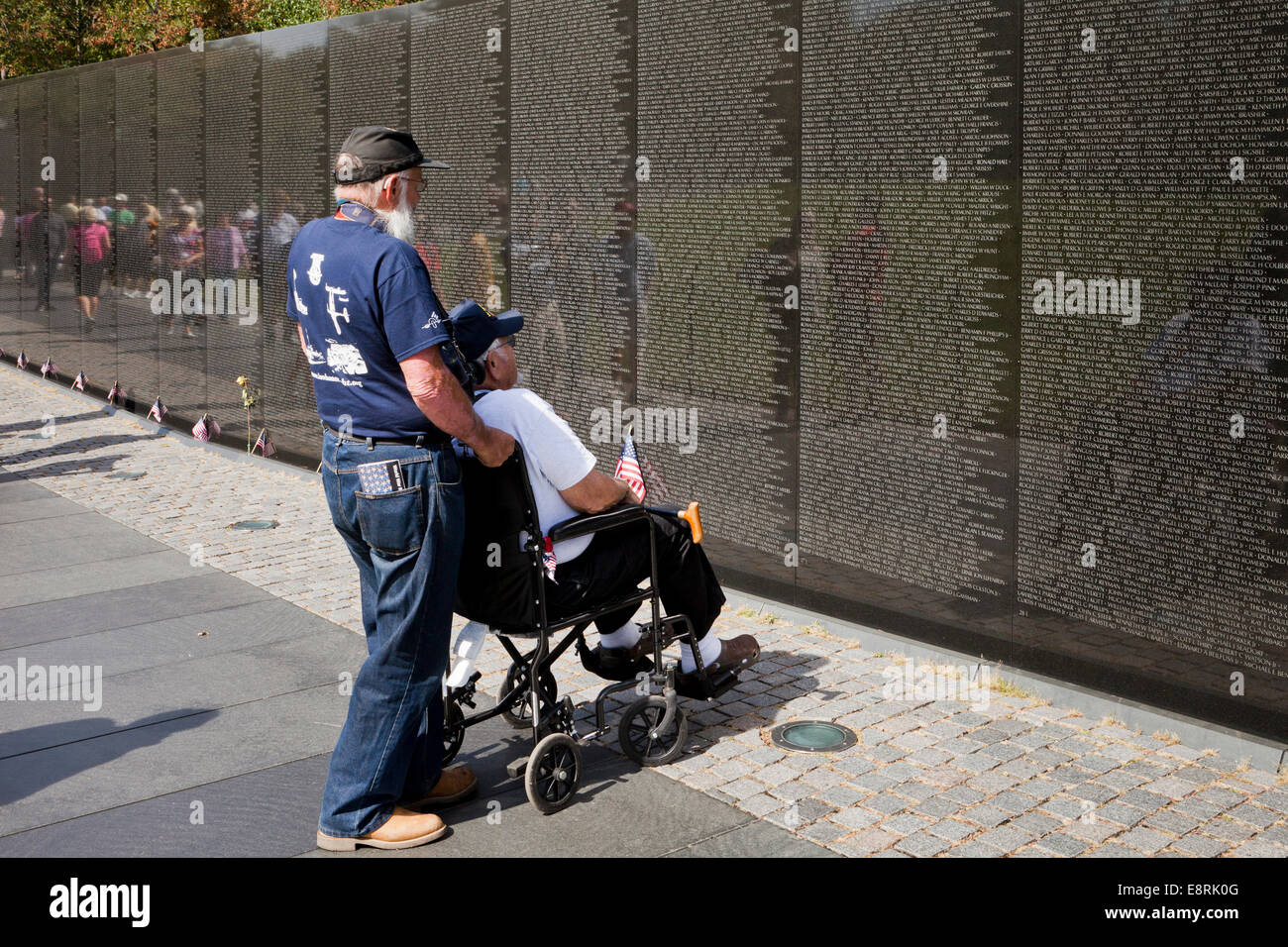 Veteran in wheelchair visiting Vietnam Veterans Memorial wall