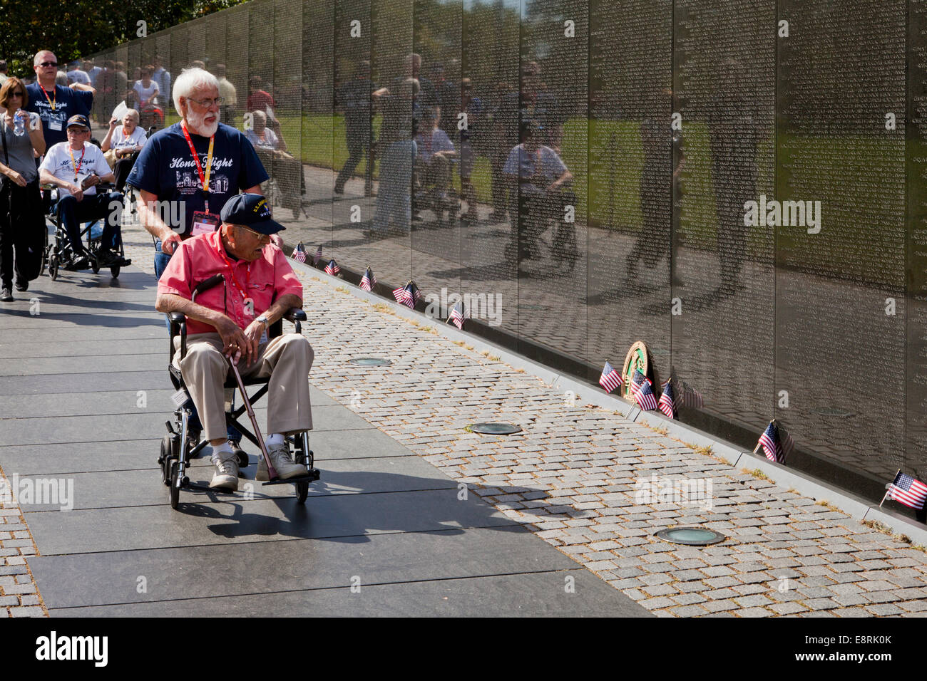 Veteran in wheelchair visiting Vietnam Veterans Memorial wall