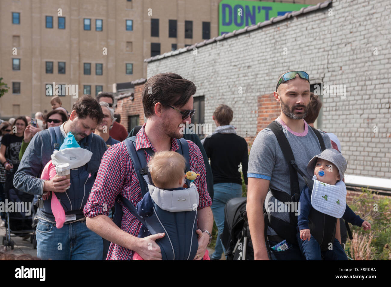 About 15 members of the NYC Dads Group celebrate International Babywearing Week with a stroll on the High Line Stock Photo