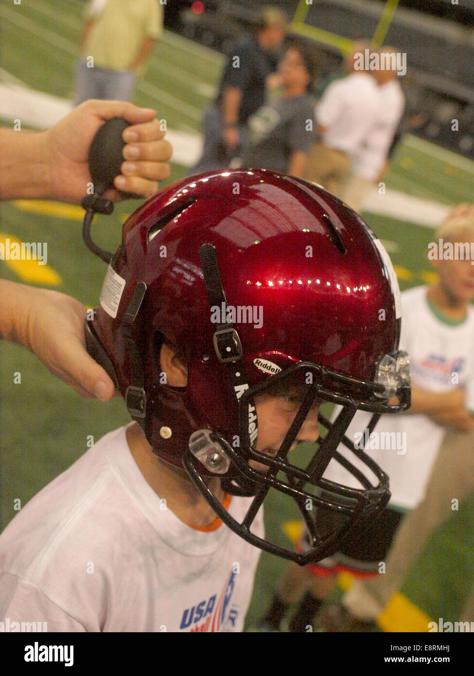 New football helmets add custom cushioning to fit the players head and