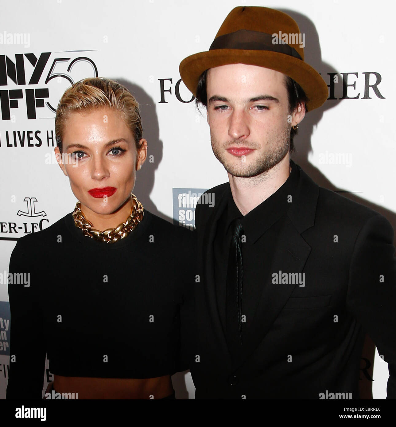 NEW YORK-OCT 10: Actress Sienna Miller (L) and Tom Sturridge attend the 'Foxcatcher' premiere at the 52nd New York Film Festival at Alice Tully Hall on October 10, 2014 in New York City. Stock Photo