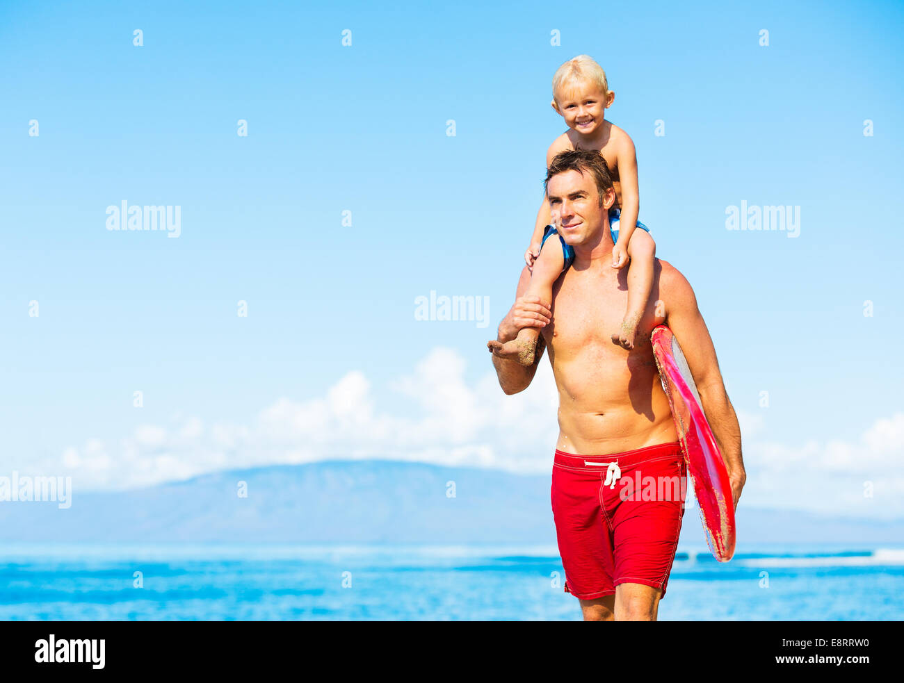 Father and Son Going Surfing at the Beach Stock Photo