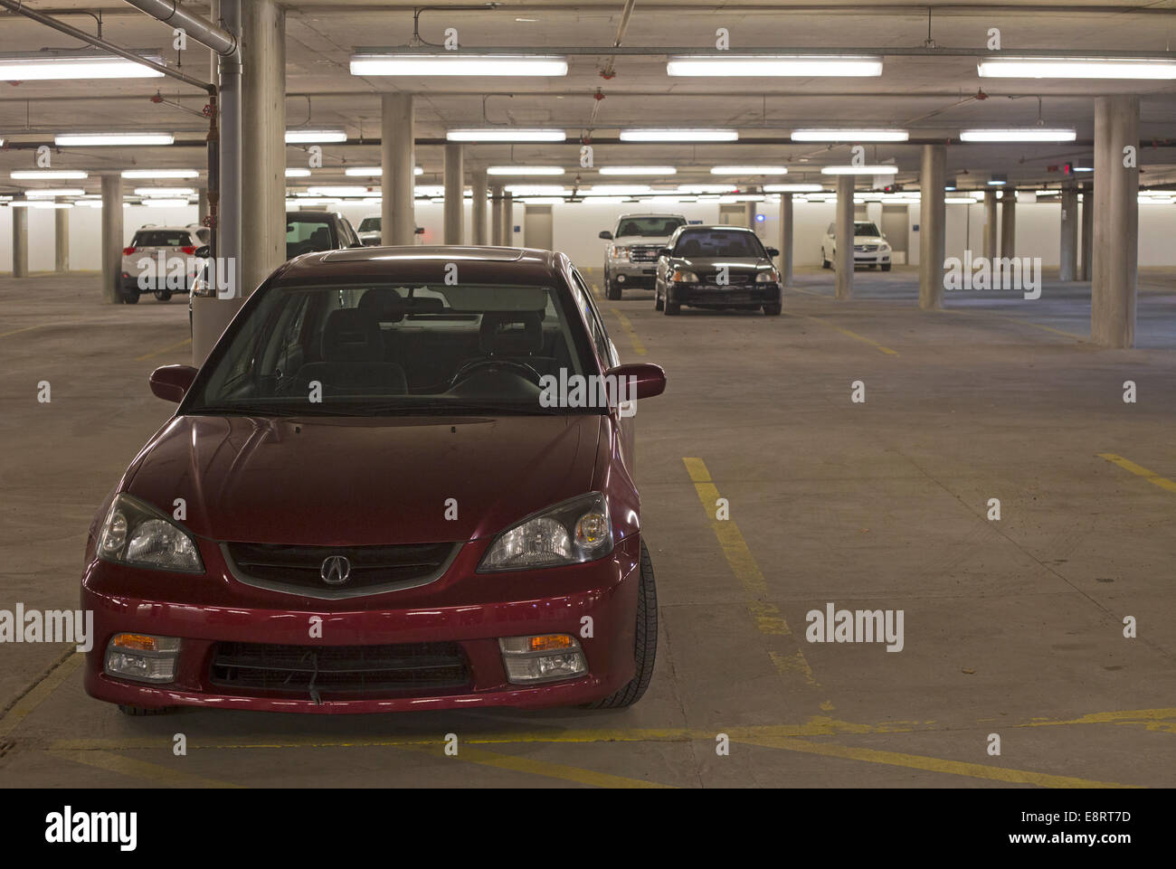 Well-lit underground parking garage Stock Photo