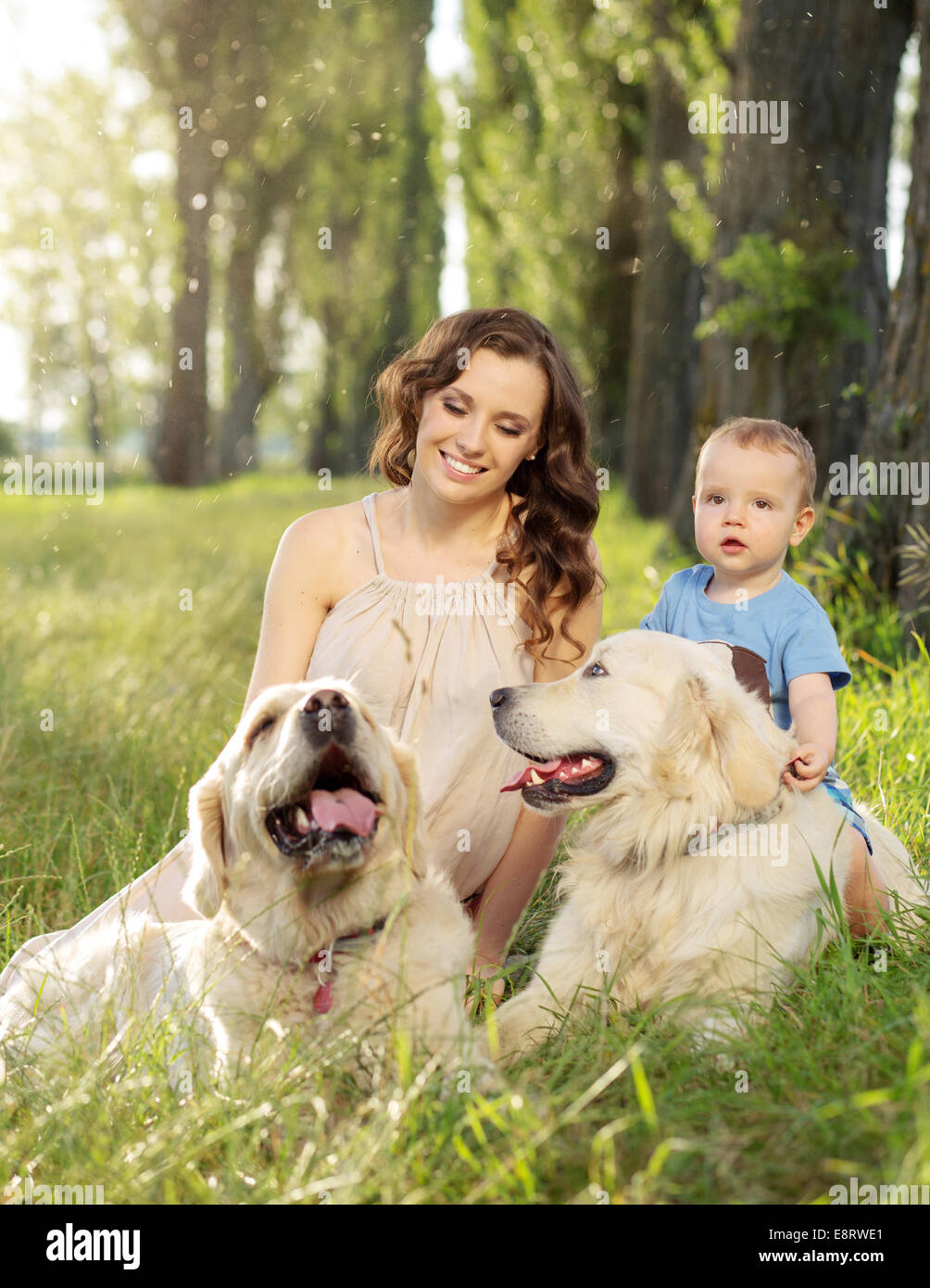 Charming woman with kid and two dogs Stock Photo
