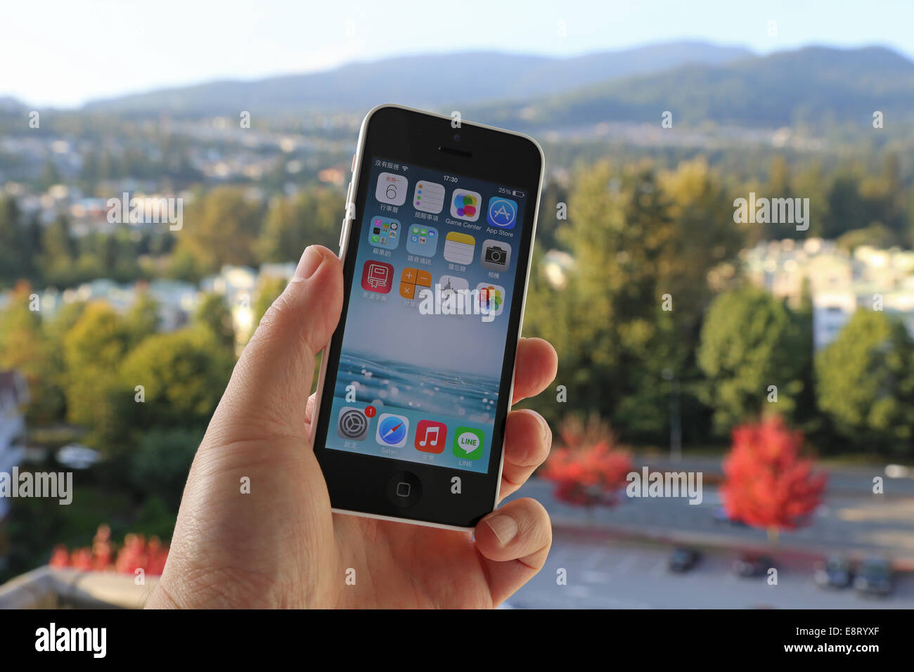 Coquitlam BC Canada - October 06, 2014 : Apple iPhone in a man's hand, the iPhone is one of the most popular smart phones Stock Photo