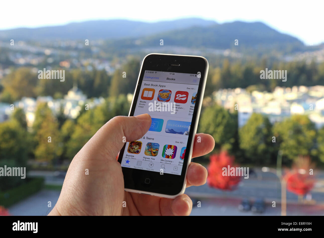 Coquitlam BC Canada - October 06, 2014 : Searching new app on iPhone with nature background, IPhone is one of the most popular Stock Photo