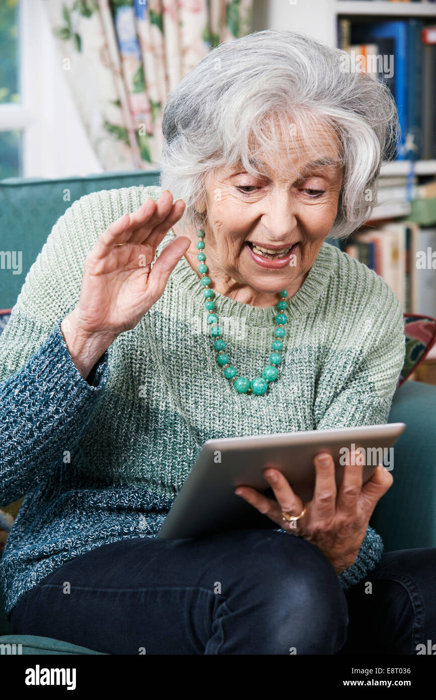 Senior Woman Making Video Call Using Digital Tablet Stock Photo