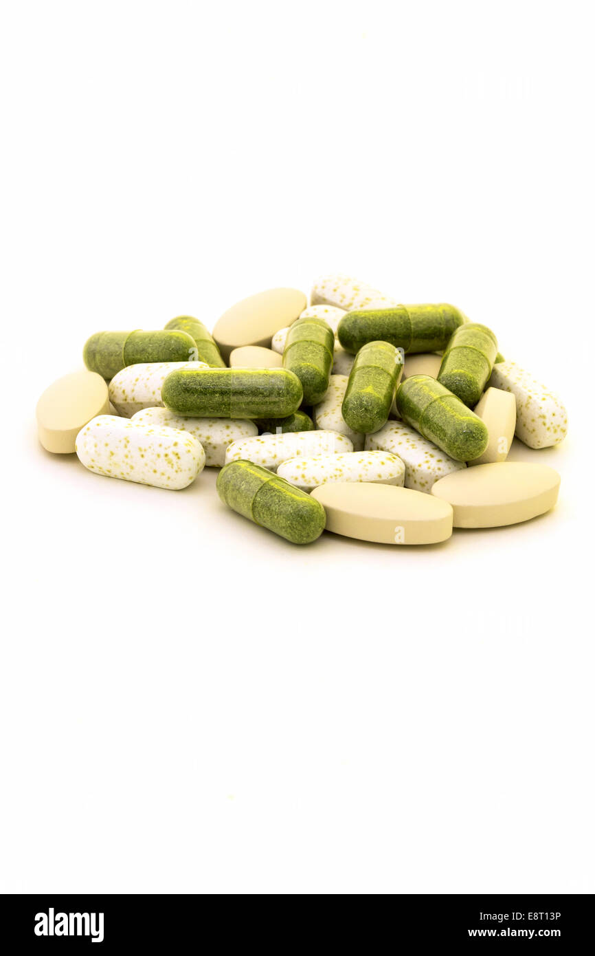 Green chlorophyll capsules on white background Stock Photo Alamy
