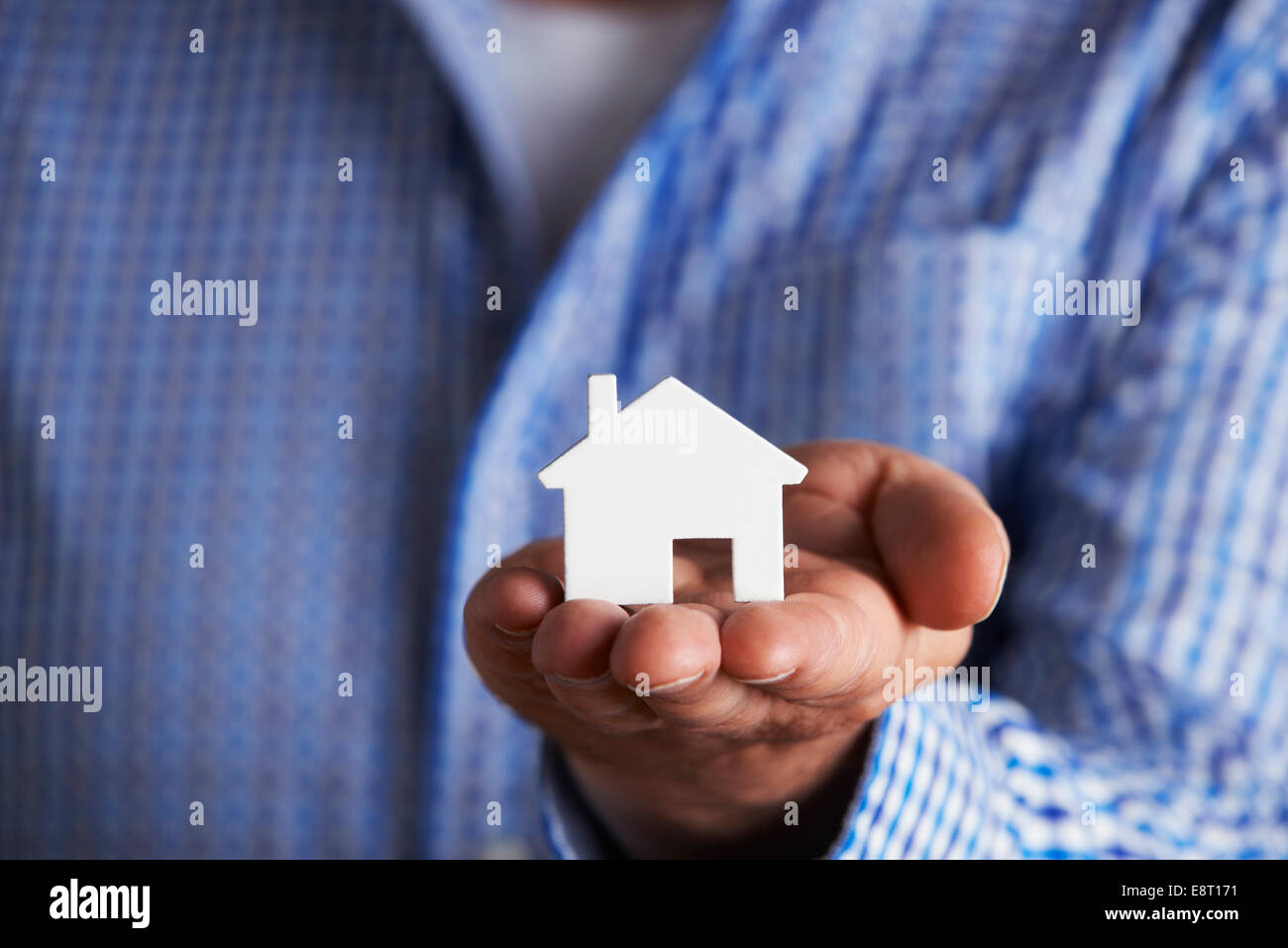 Man Holding Model House In Palm Of Hand Stock Photo - Alamy