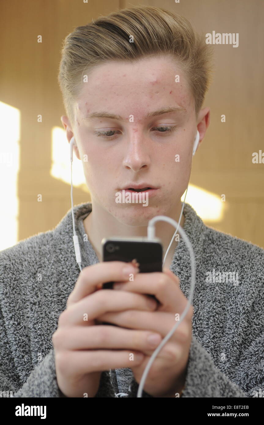 Teenage Boy Using An Apple iphone 4 Stock Photo