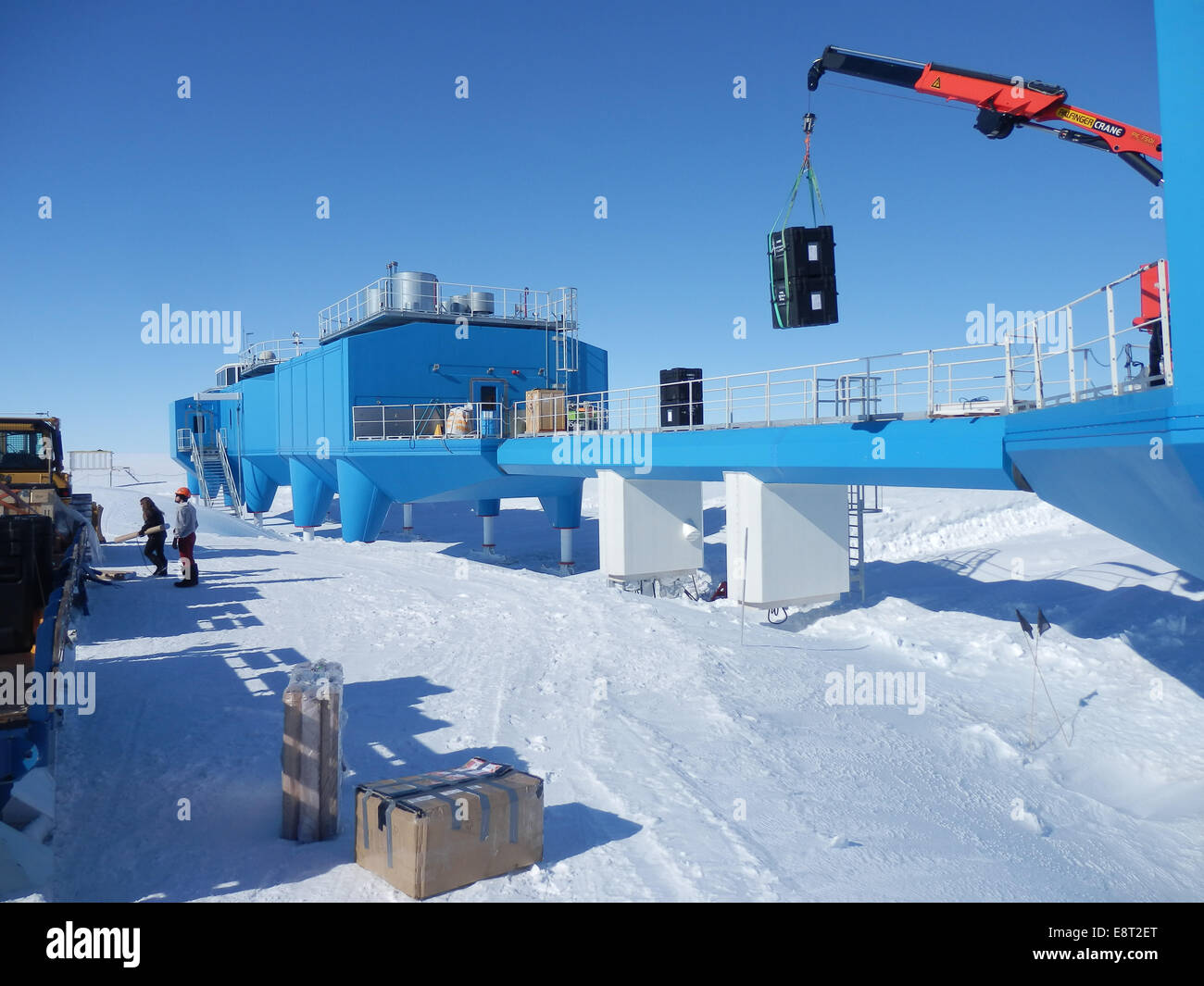 A crane lowers two BARREL balloon payloads onto the platform at Halley Research Station in Antarctica. Stock Photo