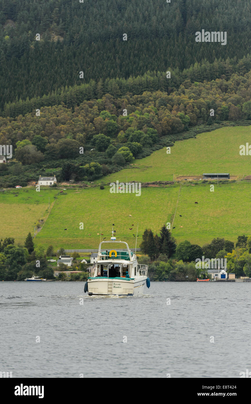 The boat, 'Nessie Hunter' pleasure cruiser takes a tourist group around Loch Ness, Drumnadrochit, Scotland. Stock Photo