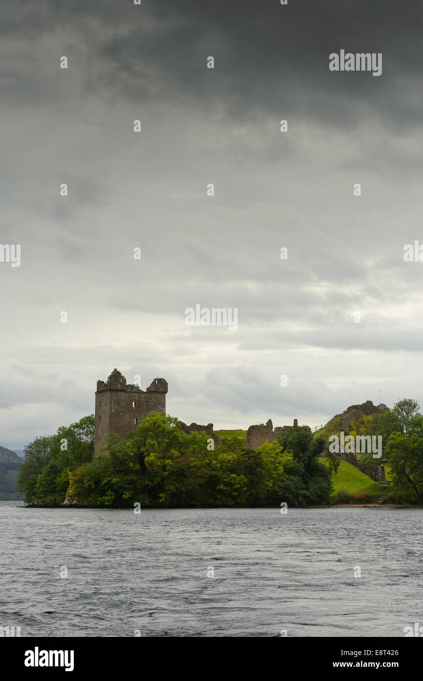 Under a gloomy cloudy overcast sky, Urquhart Castle ruins on the banks of Loch Ness near Drumnadrochit, Highland, Scotland. Stock Photo