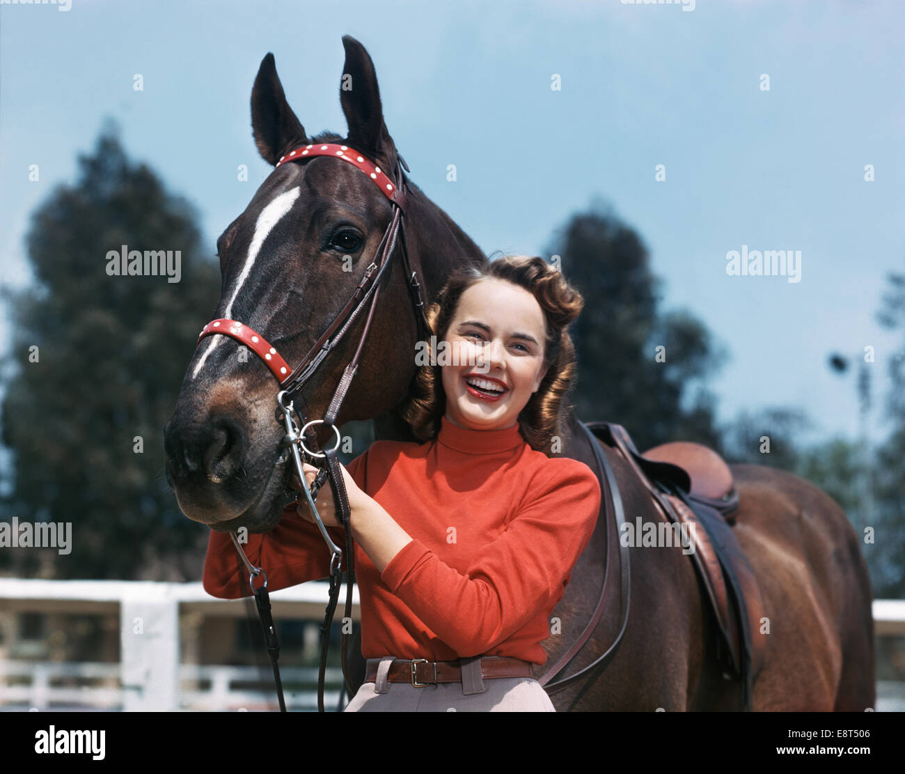 1940s 1950s SMILING TEEN GIRL POSING STANDING WITH HORSE Stock Photo