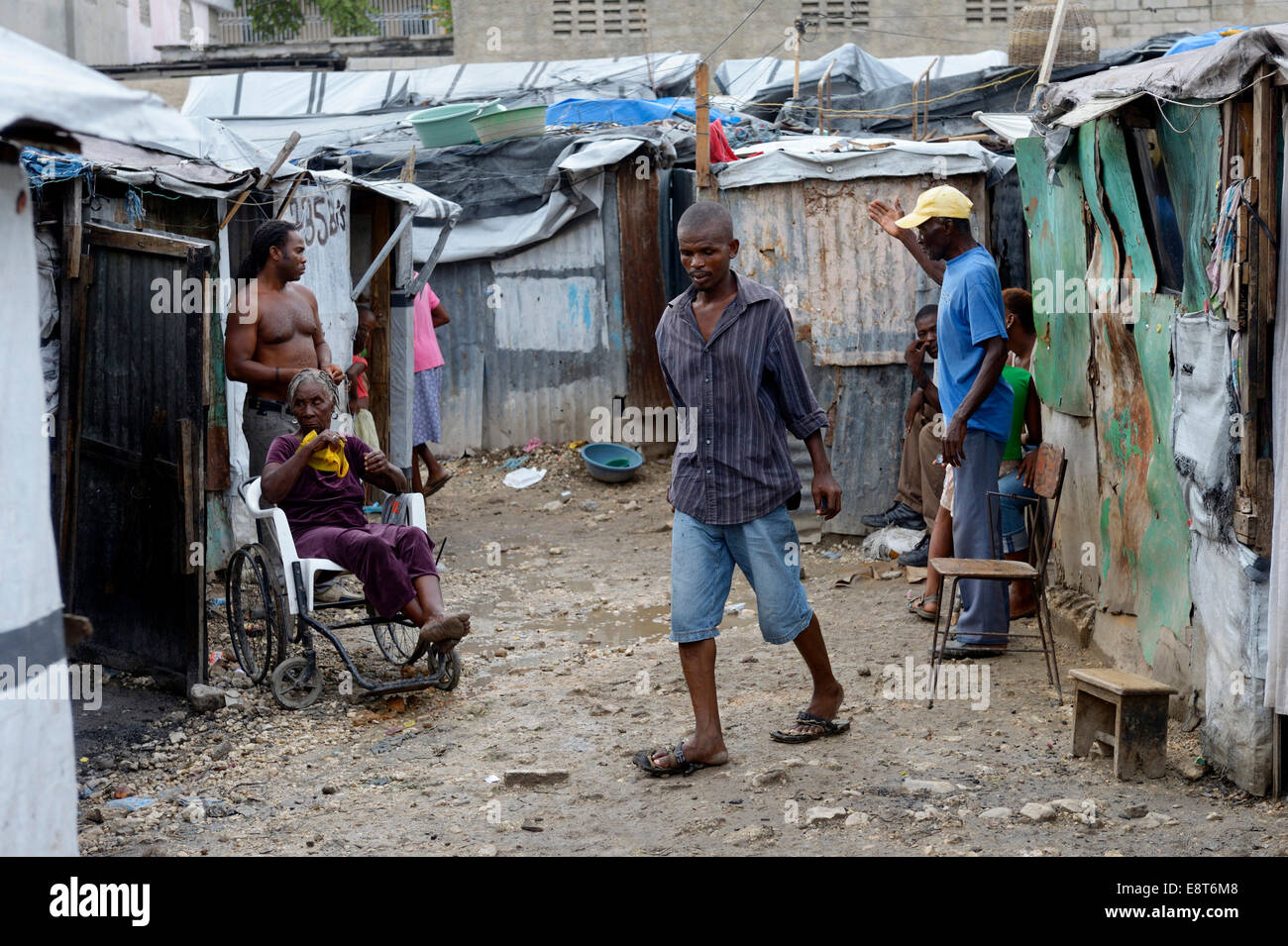 People and a sick woman in a wheelchair, Camp Icare, camp for earthquake refugees, Fort National, Port-au-Prince, Haiti Stock Photo