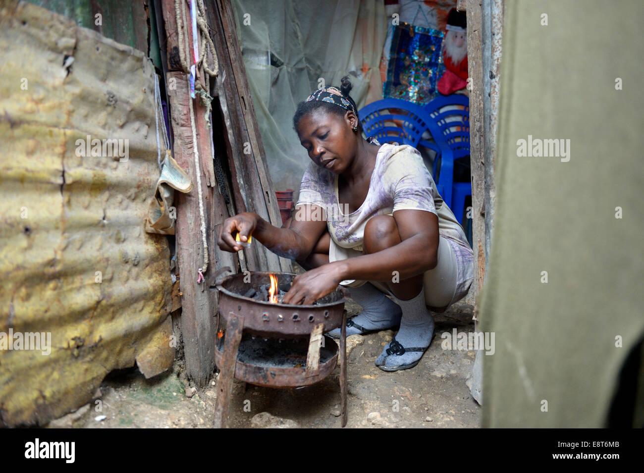 Woman cooking in the improvised kitchen of an ramshackle hut, Camp Icare, camp for earthquake refugees, Fort National Stock Photo
