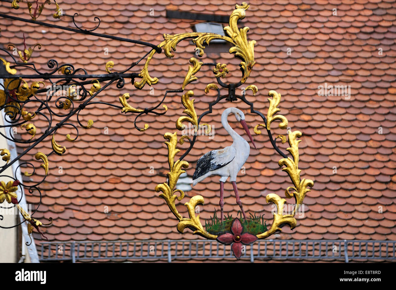 Hanging sign from the 'Zum Storchen' restaurant , in since about 1580, roof with plain tiles at back, Bad Windsheim Stock Photo