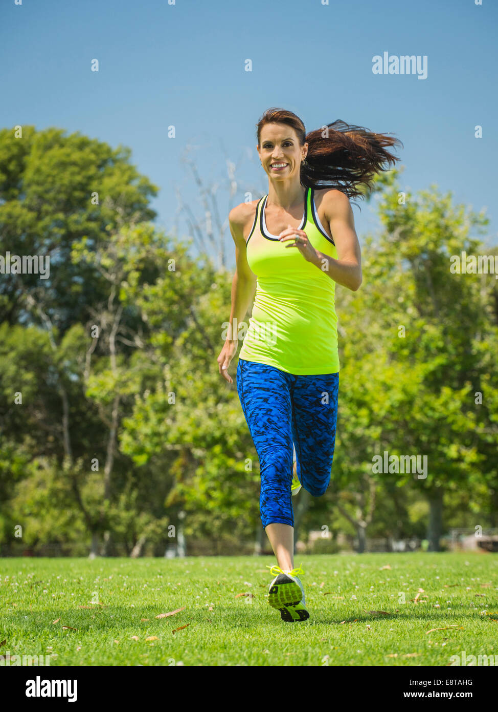 Mixed race woman jogging in park Stock Photo