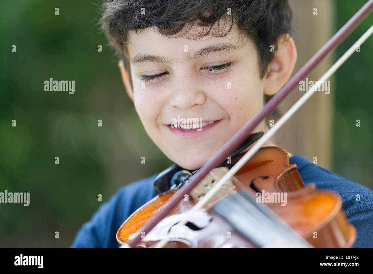 Hispanic boy playing violin Stock Photo