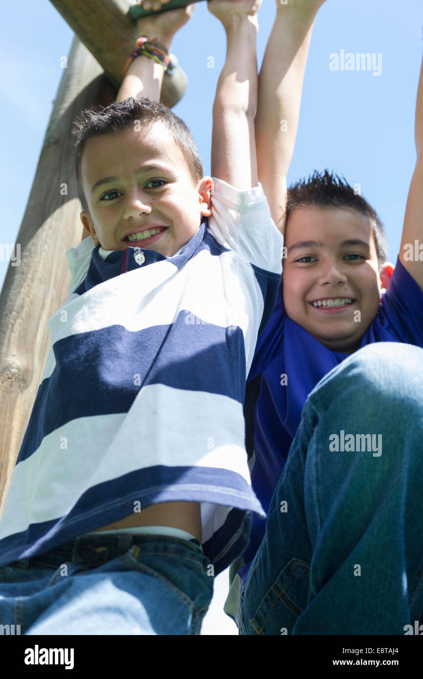 Hispanic boys playing at playground Stock Photo