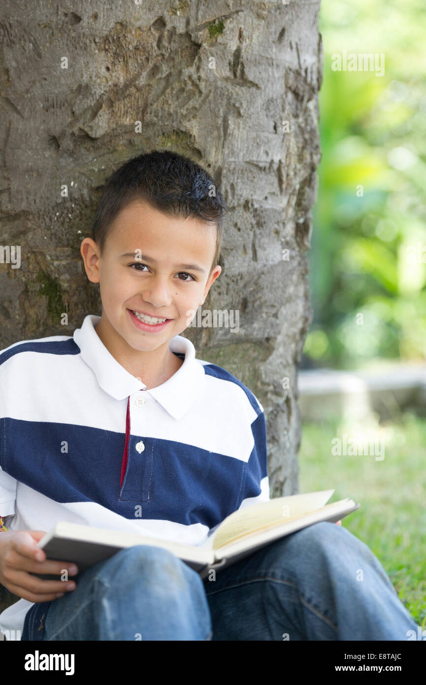 Hispanic boy reading book Stock Photo