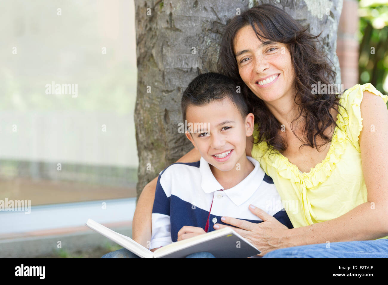 Hispanic mother and son reading book Stock Photo
