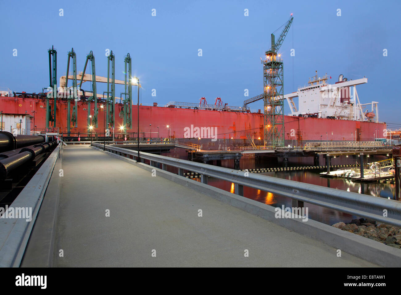 Concrete walkway to container ship in shipyard Stock Photo
